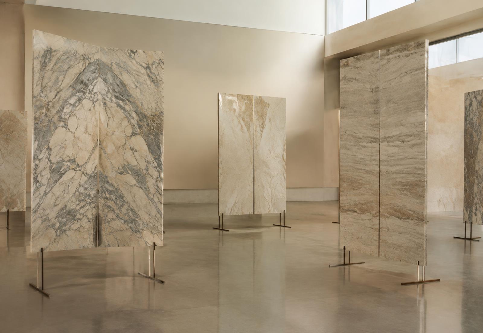 Book-matched marble and travertine slabs on display